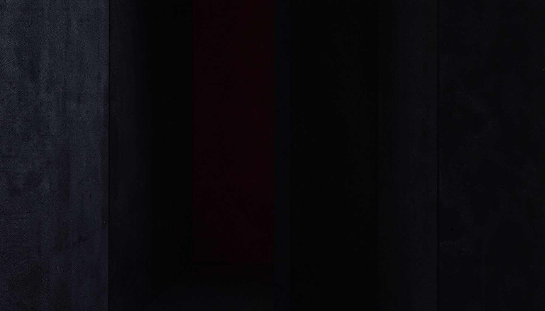 Dark atmospheric composition with deep charcoal and navy fabric textures, moody and minimal