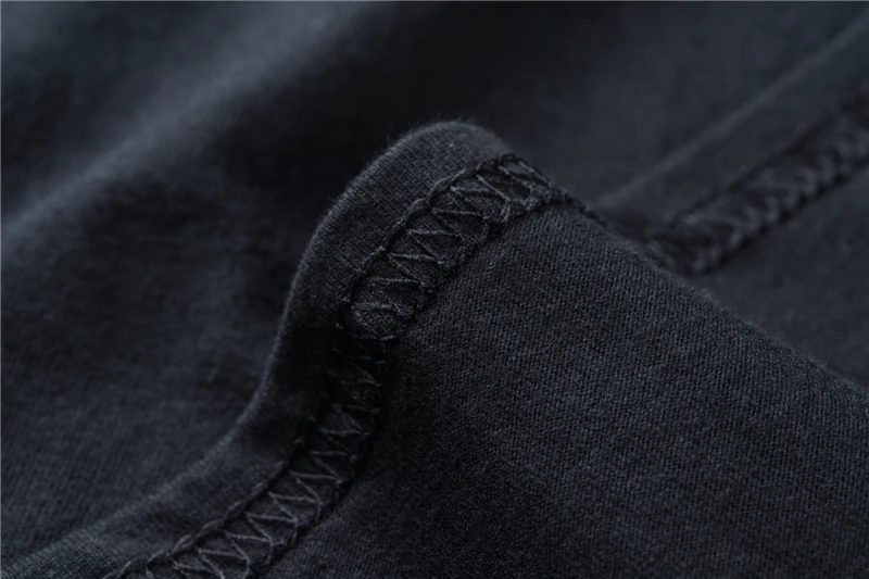 Close-up of dark navy fabric seam with zigzag stitching detail