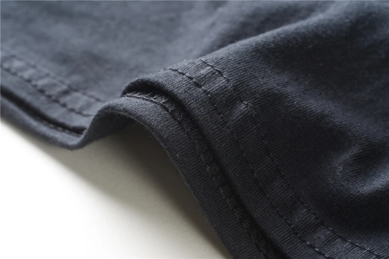 Close-up of charcoal gray fabric folded edge with visible stitching