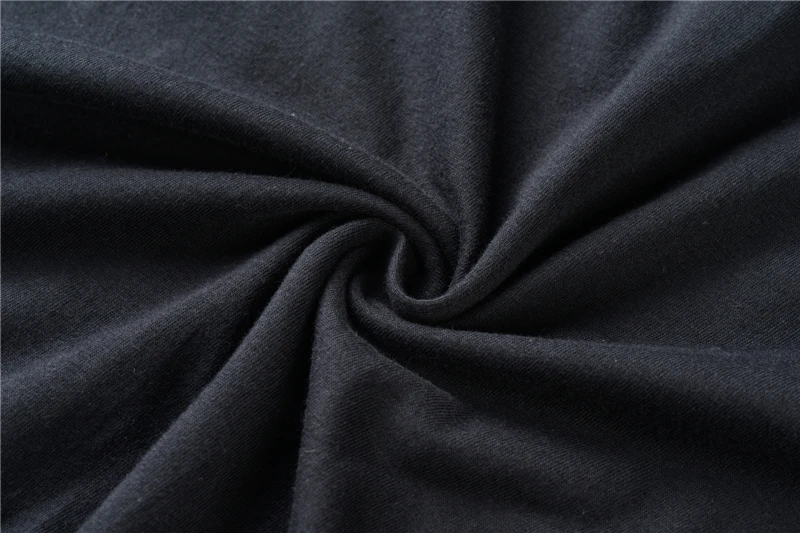 Close-up of dark twisted fabric forming a spiral swirl pattern